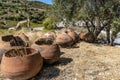 Large clay jugs for storing wine piled near a vineyard, Cyprus. Royalty Free Stock Photo