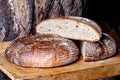 Traditional large farm-style round bread with caraway on wood bo