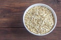 Traditional large oat flakes in a bowl on a wooden background with a copy of the space.The view from the top Royalty Free Stock Photo