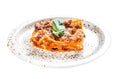 Traditional lasagna made with minced beef, bolognese and bechamel sauces. Isolated on white background. Top view. Royalty Free Stock Photo