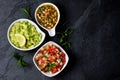 Traditional Latin American sauces Guacamole, Salsa, chili Pebre, slate background Royalty Free Stock Photo