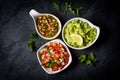 Traditional Latin American sauces Guacamole, Salsa, chili Pebre, slate background Royalty Free Stock Photo