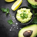 Traditional latinamerican mexican sauce guacamole on black.