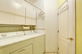Traditional laundry room with tile floor, and washer dryer combo. Royalty Free Stock Photo
