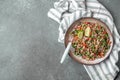 Traditional Lebanese salad tabouli tabule with quinoa, herbs, tomatoes, mint and lemon