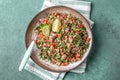 Traditional Lebanese salad tabouli tabule with quinoa, herbs, tomatoes, mint and lemon