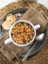 Traditional lentils chorizo with vegetables stew in white cup, spanish cuisine. Slow food concept, top view