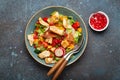 Traditional Levant dish Fattoush salad, Arab cuisine, made with pita bread croutons, vegetables and herbs. Healthy