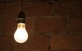traditional light bulb glowing in a dark room Royalty Free Stock Photo