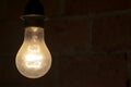 traditional light bulb glowing in a dark room Royalty Free Stock Photo