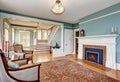 Traditional living room interior in blue and white tones, fireplace and rug Royalty Free Stock Photo