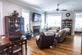 A traditional living roomwith a fireplace, hardwood floors and comfortable loveseat and armchair