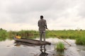 Traditional local man in mokoro boat on river through okavango delta near maun, botswana, africa. Royalty Free Stock Photo