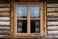 Traditional log house insulated with moss, pine wood window