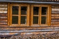 Traditional log house insulated with moss, wooden windows Royalty Free Stock Photo