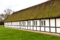 Traditional long old country house with thatched straw roof in Denmark Royalty Free Stock Photo