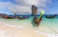 A traditional long tail boat on the beach with poda island background and blue sky