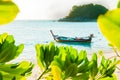 Traditional longtail boat docking in front of the beach in Lipe, Satun, Thailand; Selective focus