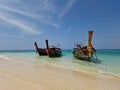 Traditional longtail boats parked on the shore of Thailand