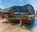 Traditional longtailed speed boats moored on the jetty of the settlement built on stilts of Ko Panyi in Phang Nga Bay, Thailand Royalty Free Stock Photo