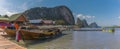 Traditional longtailed speed boats moored at the jetty of the settlement of Ko Panyi in Phang Nga Bay, Thailand Royalty Free Stock Photo