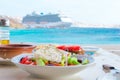 Traditional lunch with delicious fresh greek salad and brusketa served for lunch at outdoor cafe with view on the sea Royalty Free Stock Photo