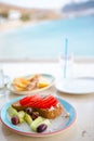 Traditional lunch with delicious fresh greek salad and brusketa served for lunch at outdoor restaurant with beautiful Royalty Free Stock Photo