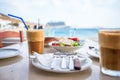 Traditional lunch with delicious fresh greek salad, frappe and brusketa served for lunch at outdoor cafe Royalty Free Stock Photo