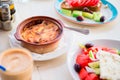 Traditional lunch with delicious fresh greek salad, frappe and musaka at outdoor cafe Royalty Free Stock Photo