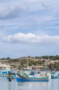 Traditional Luzzu boat at Marsaxlokk harbor in Malta. Royalty Free Stock Photo