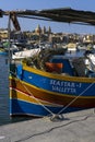 Traditional Maltese fishing boat moored to shore