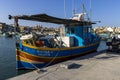 Traditional Maltese fishing boat moored to shore