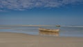 Traditional Malagasy wooden homemade piroga boats stand in shallow water