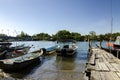 Traditional malaysian fisherman boat moored, wooden jetty and bl Royalty Free Stock Photo