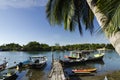 Traditional malaysian fisherman boat moored, wooden jetty and blue sky background Royalty Free Stock Photo