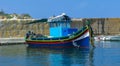 Traditional Maltese boat of fishermen at the pier on the island of Malta Royalty Free Stock Photo
