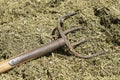 Traditional manure fork on a bale of cattle feed Royalty Free Stock Photo