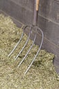 Traditional manure fork on a bale of cattle feed