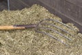 Traditional manure fork on a bale of cattle feed