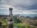 Traditional maori woid carved sculpture on the Pacific ocean coast on the South Island of New Zealand