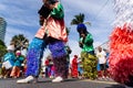 Traditional masqueraders make a presentation playing percussion Royalty Free Stock Photo