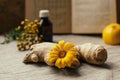 Traditional medicine background with ginger and calendula at blurred vintage recipy book, lemon,pharmacy bottle, tansy at linen Royalty Free Stock Photo