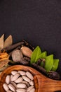 Traditional medicine concept. Close-up of herbal pills in a wooden spoon shot from the top and different spices, green leaves on Royalty Free Stock Photo