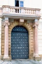 Traditional medieval door with columns and balcony