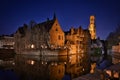 Traditional medieval houses on a canal in historical Bruges Old Town center at night, Belgium Royalty Free Stock Photo