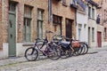 Traditional medieval town. Narrow paved street with old brick houses and bikes near entrance Royalty Free Stock Photo