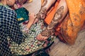 Traditional Mehndi henna pattern on female leg. Close-up photo.