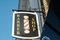 Traditional men`s barber pole sign outside a shop front. Royalty Free Stock Photo