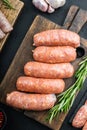 Traditional raw sausages, flat lay, on black background