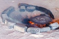 Traditional metal plate for making arabic pita bread cooking on fire in bedouin dwelling